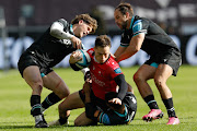 Quan Horn of the Lions is brought down during their United Rugby Championship match against the Ospreys at Swansea.com Stadium on Saturday.