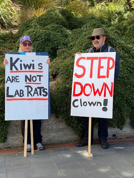 Protesters stand with placards as they rally against coronavirus disease (Covid-19) restrictions and vaccine mandates in Wellington, New Zealand, November 9, 2021.