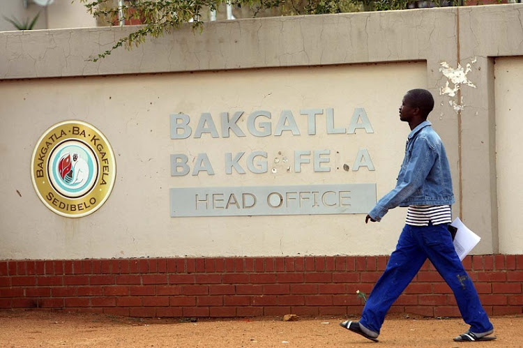 A man walks past the tribal headquarters of the Bakgatla Ba Kgafela tribe in Pilanesburg in the North West province in this March 2011 file photo.
