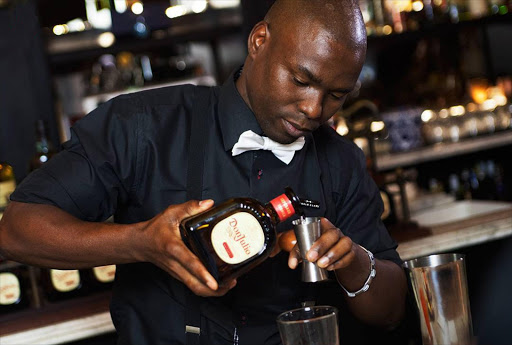 Ayanda Khanyile serves it up behind the bar.