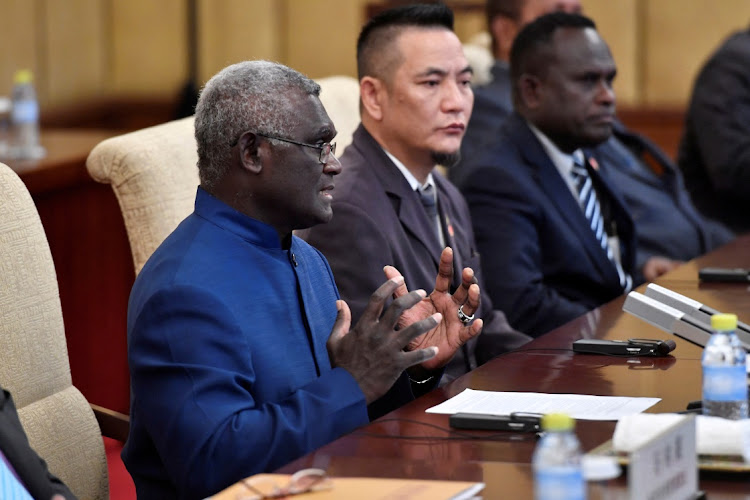 Solomon Islands Prime Minister Manasseh Sogavare talks to Chinese President Xi Jinping (not pictured) during their meeting at the Diaoyutai State Guesthouse in Beijing, China, October 9 2019. Picture: Parker Song/Reuters