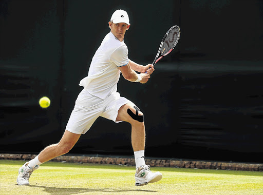 ROLLING ON: Kevin Anderson on the backhand during his second-round singles match against Edouard Roger-Vasselin of France on day three of the Wimbledon championships at the All England Lawn Tennis and Croquet Club. He won in four sets, 7-6, 1-6, 6-3, 6-4