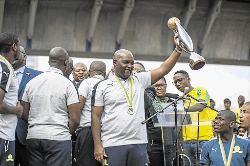 A file photo of Mamelodi Sundowns head coach Pitso Mosimane holding the Caf Champions League trophy as the team arrives at OR Tambo International Airport after they were crowned 2016 champions on October 26.
