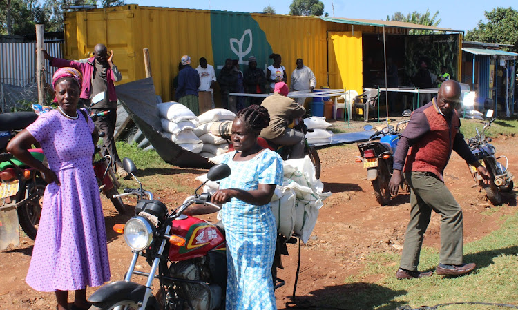 Smallholder farmers pick farm inputs at the organization's outlet in Kakamega town on Wednesday.