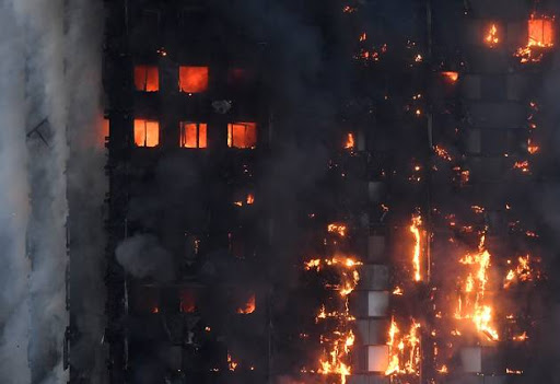 Flames and smoke billow as firefighters deal with a serious fire in a tower block at Latimer Road in West London, Britain June 14, 2017.
