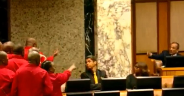 An EFF MP appears to pull the middle finger at a fellow MP as the party walked out of the state of the nation address on Thursday night.