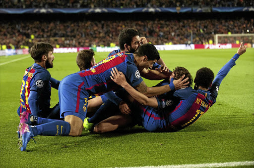 Barcelona players celebrate their victory after the Champions League last-16 second leg match against Paris Saint-Germain at the Nou Camp.