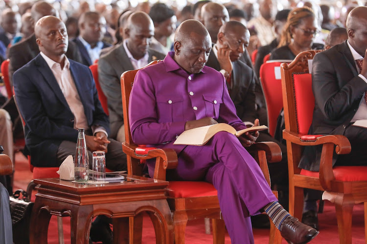President William Ruto reads his Bible during a church service in Iten, Elgeyo Marakwet on January 14, 2024