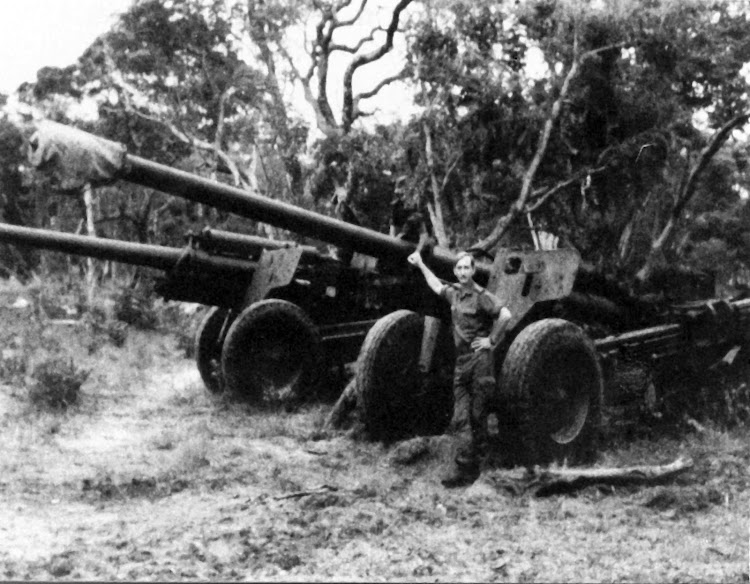 Commander of 20 SA Brigade. Colonel P. S. Fouché with two M-46 Russian artillery pieces taken by the SADF during the Operation Hooper attack on 21 Brigade.