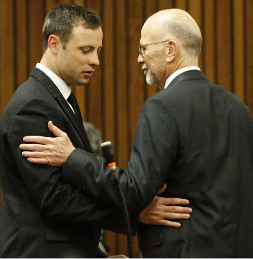 South African Paralympic athlete Oscar Pistorius (R) chats to his uncle Arnold (L) ahead of the verdict in his murder trial in Pretoria, South Africa, 12 September 2014. Judge Thokozile Masipa found South African Paralympic athlete Oscar Pistorius not guilty of the murder of Reeva Steenkamp in February 2013 but guilty of culpable homicide. EPA/ALON SKUY / POOL
