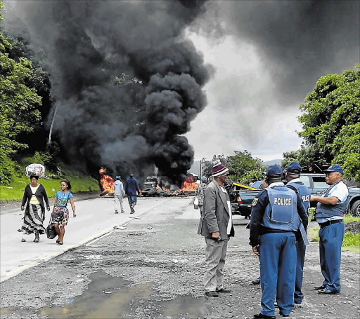 MUTINY: Port St Johns municipal workers blocked the main road into town yesterday demanding the removal of several senior officials including the municipal manager Picture: SIKHO NTSHOBANE