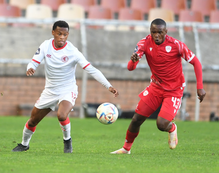 Asanele Velebayi of Cape Town Spurs is challenged by Asekho Tiwani of Sekhukhune United in their DStv Premiership match at Peter Mokaba Stadium in Polokwane on Saturday.