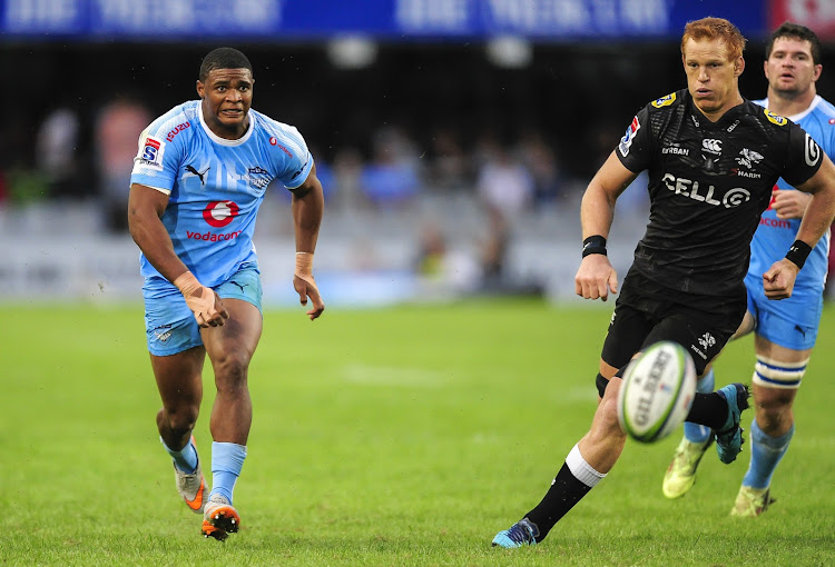 Warrick Gallant (L) of the Vodacom Bulls and Philip van der Walt of the Cell C Sharks (R) chase after the rolling ball during the Super Rugby game at Kings Park in Durban on 14 April 2018.