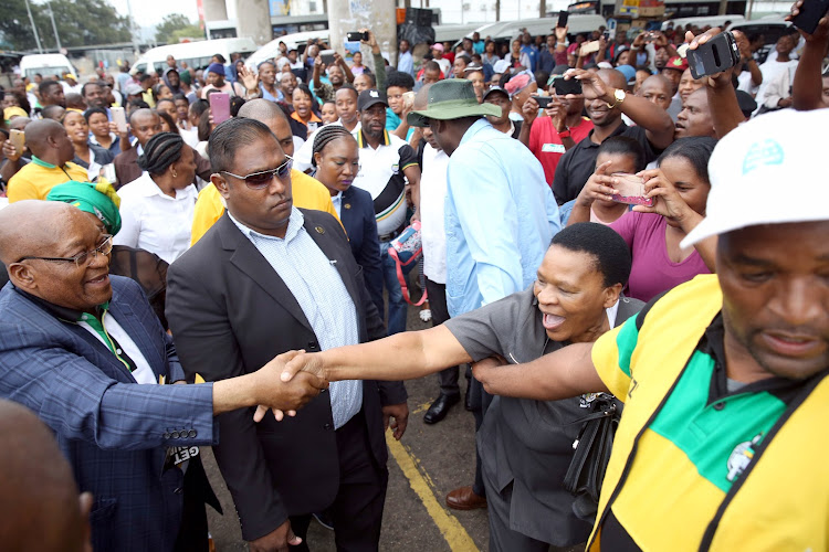 Former president Jacob Zuma greets supporters at the Pinetown taxi rank in Durban on November 16 2018.