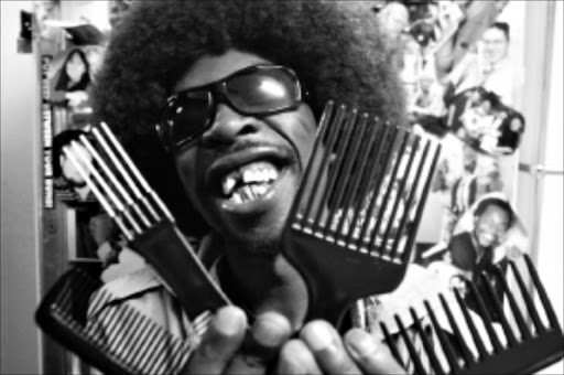 DON'T TANGLE WITH ME: Classical musician-turned- hip-hopper Pitch Black Afro with a bunch of combs. Pic. LEBOHANG MASHILOANE. 26/01/2010. © TIMES 26 JANUARY 2010 Musician Pitch Black Afro testing out combs. PICTURE: LEBOHANG MASHILOANE ------ 35 acros full pic