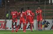 Mothobi Mvala (R) celebrates with teammates after scoring the opening goal.   