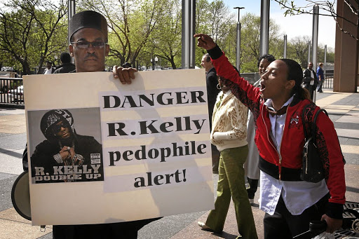 R. Kelly supporters take on a lone protestor as the musician's trial on charges of child pornography got under way in Chicago in 2008. Kelly was acquitted.