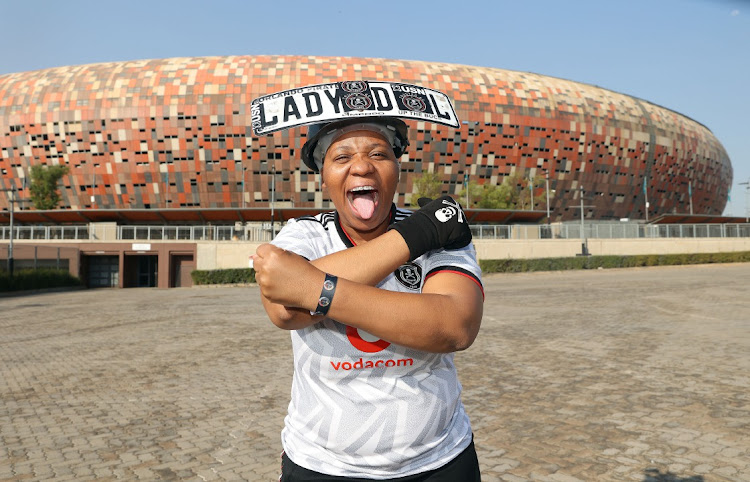 Orlando Pirates super-fan Lady D Iron Lady poses for a picture during the launch of the Black Label Cup at FNB Stadium.
