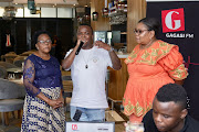 Dlala Thukzin's grandmother Ntombifikile Zindlovu, DJ Dlala Thukzin and Gagasi FM content specialist Thola Khumalo.