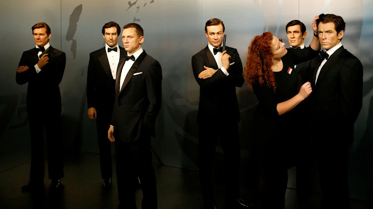 Wax figures of six of the actors who have portrayed James Bond - left to right, Roger Moore, Timothy Dalton, Daniel Craig, Sean Connery, George Lazenby and Pierce Brosnan - in the Madame Tussauds wax museum in Berlin, Germany.