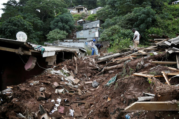 Men sift through the rubble of a church which collapsed onto a house killing four children in Clermont, Durban, South Africa, April 13, 2022