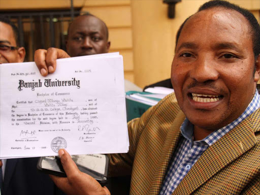 Kabete MP Ferdinand Waititu shows his degree to the media at Milimani courts after the hearing of a case in which Kiambu Governor William Kabogo has sued him over academic qualification.Photo/PHILIP KAMAKYA