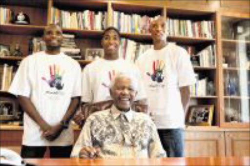 MAGIC MOMENT: Nelson Mandela yesterday congratulated South Africa's athletes who won medals at the World Athletics Championships in Berlin. The men's and women's 800m goldmedallists, Mbulaeni Mulaudzi and Caster Semenya, and long jump silver medallist Khotso Mokoena with Mandela in Houghton, Johannesburg. Pic: JOHN HOGG/THE NELSON MANDELA FOUNDATION