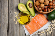 There is no food containing fat which doesn't contain all three types of fat; saturated, mono-unsaturated and polyunsaturated. Salmon, for instance, has around 3.5 grams saturated fat per 100g.