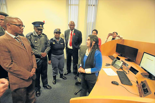 SEEING FOR HIMSELF: SAPS 10111 call centre operator Kathy Naidoo shows national Deputy Police Minister Bongani Mkhongi the day-to-day operations at the centre Picture: SINO MAJANGAZA