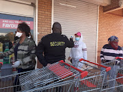 A women getting her temperature taken outside the Makro in Springfield, Durban, before the store opened at 9am.