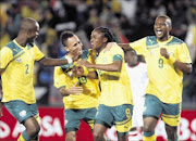 WELL DONE: Bafana Bafana players celebrate after Siphiwe Tshabalala's goal against  Burkina Faso during their friendly  match at Ellis Park Stadium in Johannesburg last night.  PHOTO: ANTONIO MUCHAVE