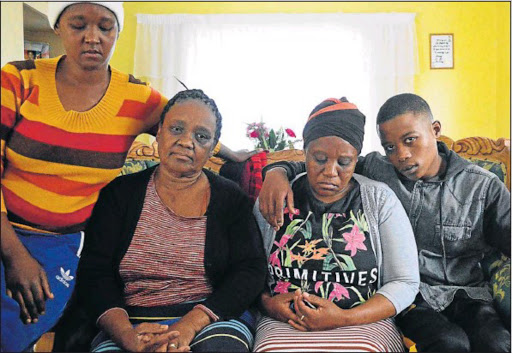 The Roberts family is in shock over the way their little boy Mpho, 6, top right, lost his life in his brother Romeo's arms on Tuesday morning at Empilweni Clinic in Gompo. Pictured are Mpho’s aunt Jeanie, Johanna, Mpho’s mother Marilyn, and his brother Romeo in their Buffalo Flats home. PICTURE: RANDELL ROSKRUGE