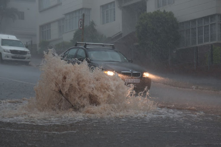 A car braves a flooded Durban street on Tuesday afternoon.