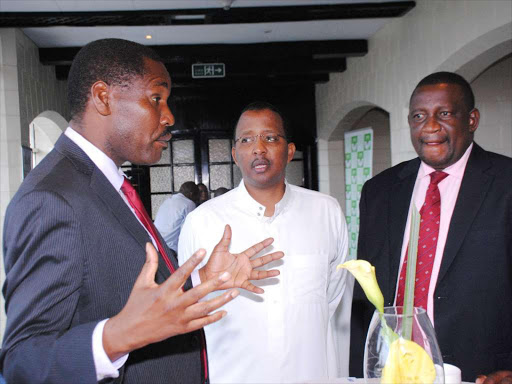 Council of Governors Chairman Peter Munya, Independent Electoral Commission Chairman Isack Hassan and Kwale County Governor consult each other before addressing a press conference yesterday at Intercontinental Hotel. photo/PATRICK VIDIJA
