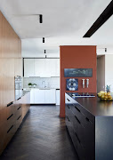 The kitchen includes two sections – one part hidden behind a terracotta wall.