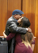 Cheryl Zondi with her father Mxolisi Zondi in court during her testimony  against pastor Timothy Omotoso in the PE high court. 