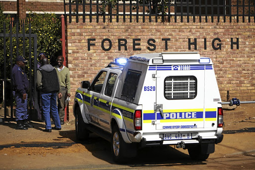 Police patrol outside Forest High School, South of Joburg, where a student was stabbed to death by another pupil. /Alaister Russell