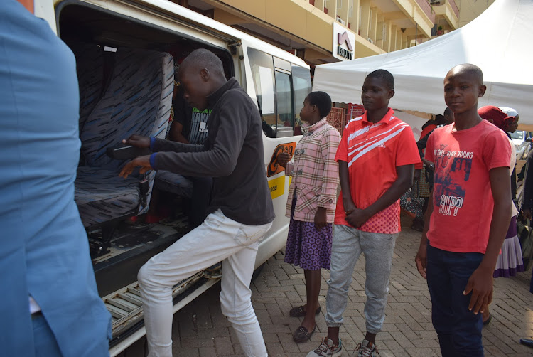 Some Wings To Fly scholars enter a motor vehicle for Nairobi during flagging off in Homa Bay town on January 4,2024