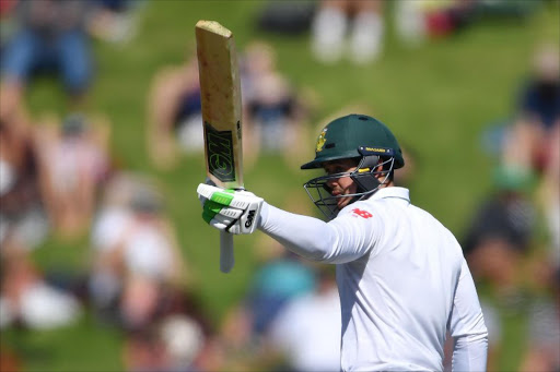 South Africa's keeper Quinton de Kock celebrates 50 runs during day two of the second Test cricket match between New Zealand and South Africa at the Basin Reserve in Wellington on March 17, 2017.