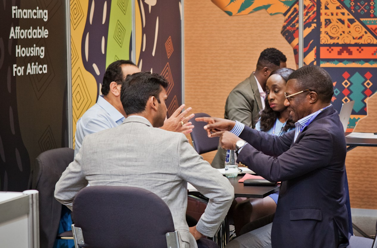 Shelter Afrique acting CEO Kingsley Muwowo (right) engaging delegates at the 11th World Urban Forum held in the Polish city of Katowice/SHELTER AFRIQUE