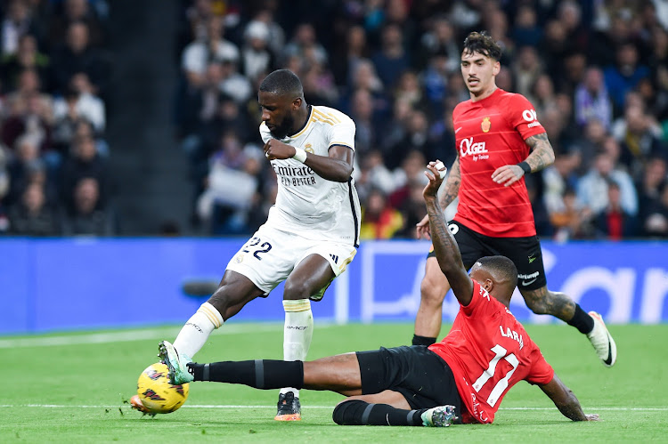 Real Madrid's Antonio Rudiger (L) of vies for the ball with Cyle Larin of Mallorca