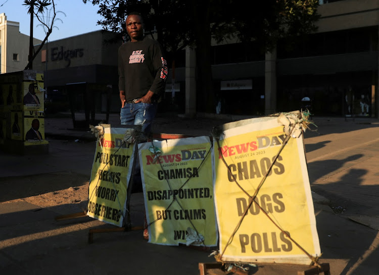 A man walks past newspaper posters along a street in Harare, Zimbabwe, August 24 2023. Picture: PHILIMON BULAWAYO/ REUTERS