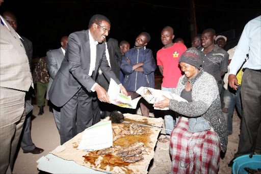 kibra at night: Goreti Atieno, ‘Mama Samaki’ sells fish to Kenya Power MD Ben Chumo in Kibra on March 17.