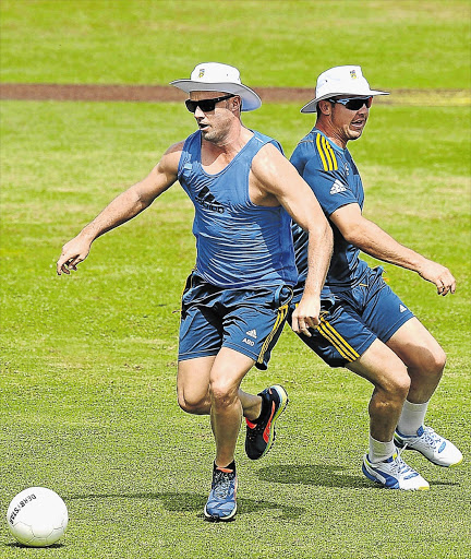 GET YOUR KICKS: AB de Villiers, left, and team-mate Dean Elgar warm up with some football during a Proteas practice at the Galle International Cricket Stadium in Galle, Sri Lanka, yesterday