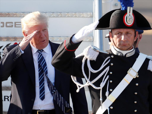 US President Donald Trump salutes as he arrives at the Leonardo da Vinci-Fiumicino Airport in Rome, Italy, May 23, 2017. /REUTERS