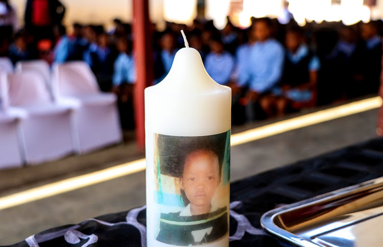 A memorial service at Durban Deep Primary School honoured 10-year-old Kopano Molelekedi. The image on the candle is of Kopano's graduation to Grade 5 at the school and it is one of the last photos taken of the little girl.