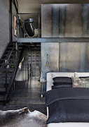 Raw steel panelling divides the bedroom from the ensuite bathroom.