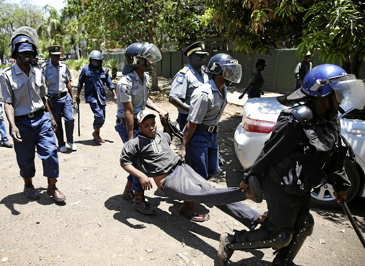 Zimbabwean police carry a protester during a march on government offices in Harare in 2019. The country's government has been criticised in a report by Amnesty International for its nationality laws which have seen thousands of its citizens rendered stateless. File photo.