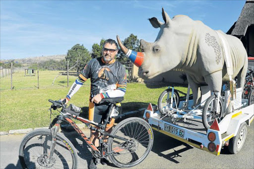 RHINO RIDE: Cyclist Wayne Bolton and his co-traveller ‘Olli’ the rhino arrived safely at Mpongo Park yesterday as part of the 2 000km One Land Love It Frontier Ride. The cycle bid to help save the rhino will visit 20 game reserves by the time the journey ends on August 1 Picture: RANDALL ROSSKRUGE