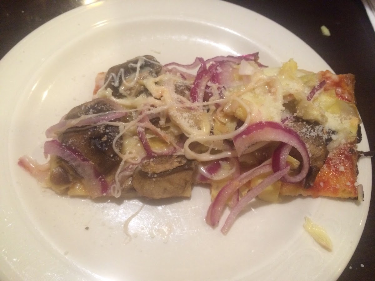 Delicious gluten free 12" pizza with artichokes, mushrooms, and red onion